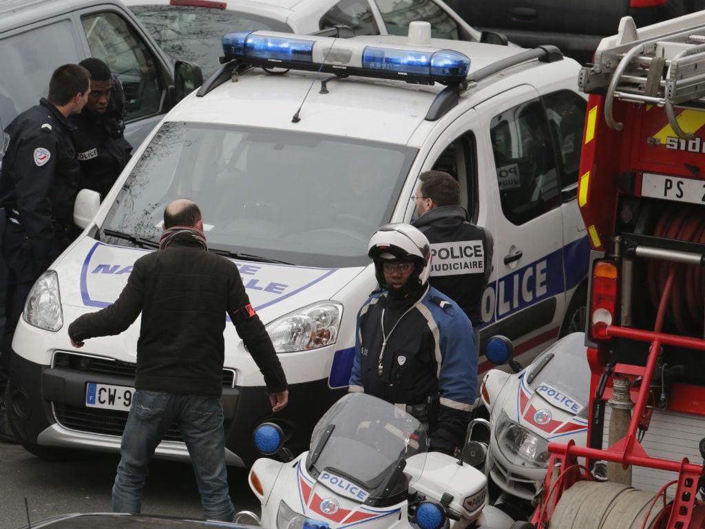 Retirada dos feridos após tiroteio no «Charlie Hebdo» (REUTERS)