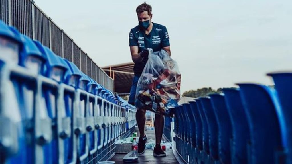 Sebastien Vettel a apanhar lixo em Silverstone (Aston Martin F1)