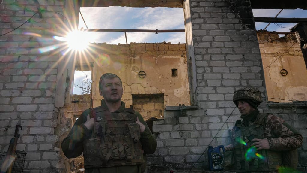 Soldados ucranianos junto a uma casa destruída na região de Lugansk. Foto: Vadim Ghirda/AP