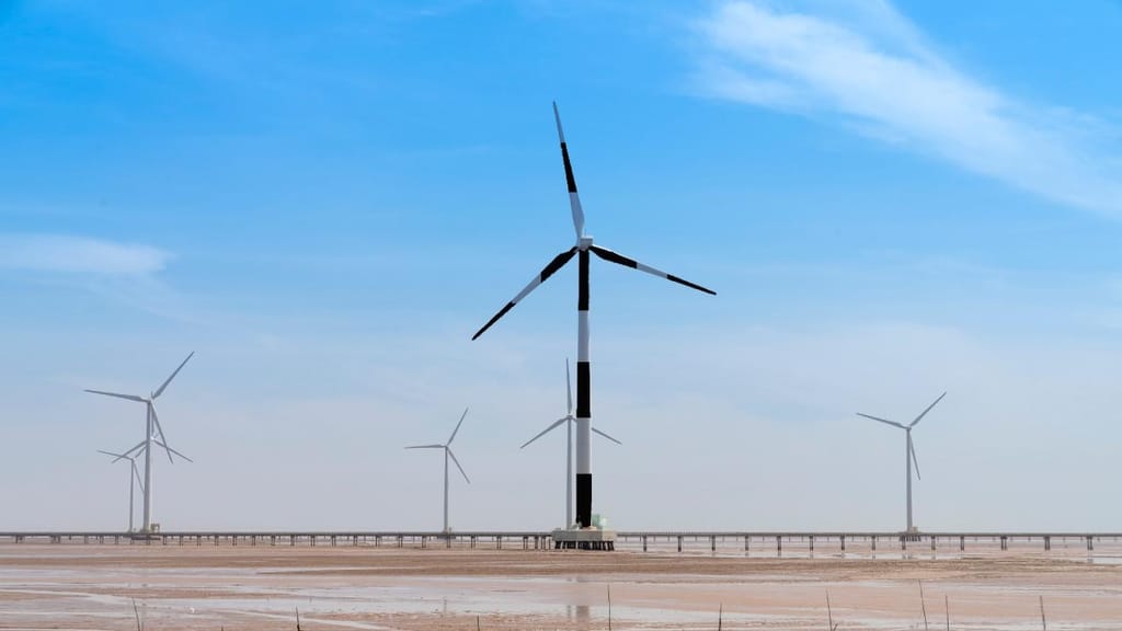 Turbinas eólicas às riscas (fotomontagem: AWAY com foto Quang Nguyen/Unsplash)