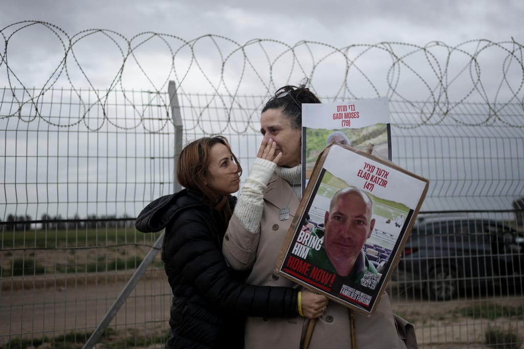 Familiar de Elad Katzir segura foto de refém do Hamas e é confortada por familiar de outro refém
